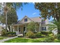 Charming single Gathering home with a inviting front porch surrounded by lush landscaping at 11415 N Camden Commons Dr, Windermere, FL 34786