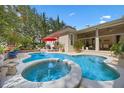 Inviting backyard pool and spa area perfect for relaxation and entertaining with a covered patio at 11415 N Camden Commons Dr, Windermere, FL 34786