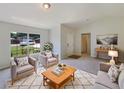 Bright living room features neutral tones, natural light, and comfortable seating arrangement at 131 Pecan Pass, Ocala, FL 34472
