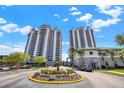 Stunning high-rise condo building with well-manicured landscaping and a central fountain at 13415 Blue Heron Beach Dr # 409, Orlando, FL 32821