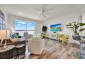Bright living room with a waterfront view, modern furnishings, and wood-look flooring at 13415 Blue Heron Beach Dr # 409, Orlando, FL 32821