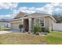 Single-story home boasting a well-kept lawn, paved driveway, and a convenient two-car garage at 140 Highland Meadows St, Davenport, FL 33837