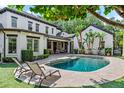 Inviting backyard pool area surrounded by lush landscaping and patio seating at 141 S Phelps Ave, Winter Park, FL 32789