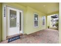 Charming covered porch features brick flooring and views to the neighborhood at 14244 Walcott Ave, Orlando, FL 32827