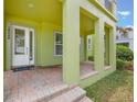A spacious front porch with brick flooring, architectural columns, and a welcoming entrance at 14244 Walcott Ave, Orlando, FL 32827