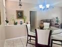 The dining area has a glass table, white chairs, and decorative plants, flowing into the living room at 1449 Amanda Rd, Kissimmee, FL 34744