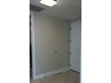Neutral hallway featuring a coat closet and entry door, offering functionality and clean design at 150 E Robinson St # 2002, Orlando, FL 32801