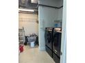 Well-equipped laundry room with modern washer, dryer, storage shelves, and ample space at 150 E Robinson St # 2002, Orlando, FL 32801
