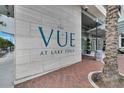 Exterior signage for The Vue at Lake Eola on a textured stone wall, with a landscaped walkway at 150 E Robinson St # 2002, Orlando, FL 32801