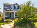 Charming two-story home with landscaped yard and walkway leading to covered front porch at 15959 Pantuso Aly, Winter Garden, FL 34787