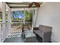 Comfortable screened porch area with cozy seating, coffee table, and relaxing outdoor views at 1650 Old Eustis Rd, Mount Dora, FL 32757