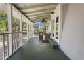 Inviting screened porch with seating, ceiling fan, and views of the landscaped yard at 1650 Old Eustis Rd, Mount Dora, FL 32757