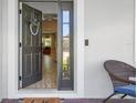 Welcoming front door with a decorative wreath, sidelights, and a view into the foyer at 17226 Hickory Wind Dr, Clermont, FL 34711