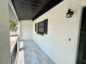 A cozy covered porch featuring decorative railing and tiled flooring at 2007 N Hastings St, Orlando, FL 32808