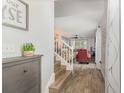 Inviting entryway showcasing wood floors, a staircase leading up, and a view into the cozy living area at 2117 Stone Abbey Blvd, Orlando, FL 32828