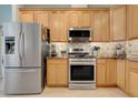 Stainless steel appliances and wooden cabinets are features of this functional and stylish kitchen at 27401 Pine Straw Rd, Leesburg, FL 34748
