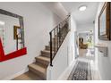 Bright entryway with wood stairs, iron railing, decorative mirrors, and access to living area at 2750 Ocean Shore Blvd # 350, Ormond Beach, FL 32176