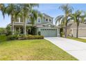 Inviting two-story home with a well-manicured lawn, lush landscaping, and a spacious two-car garage at 2842 Balforn Tower, Winter Garden, FL 34787