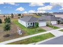 Wide aerial view of a single-story home with manicured lawn on a spacious lot in a residential neighborhood at 3017 Ambersweet Pl, Clermont, FL 34711