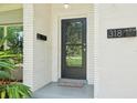 A close-up of the home's front entry, complete with a sleek door and modern address plate at 318 E Jersey St, Orlando, FL 32806