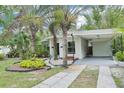 Inviting single-story home with carport, mature landscaping, and a welcoming front entrance at 318 E Jersey St, Orlando, FL 32806