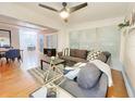 Bright living room featuring hardwood floors, neutral paint, modern furnishings, and a ceiling fan at 318 E Jersey St, Orlando, FL 32806