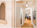 Hallway view leading to the living room showcasing hardwood floors and an arched doorway at 3643 Calabria Avenue, Davenport, FL 33897