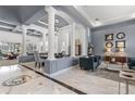 Spacious living room with high ceilings, elegant columns, and marble floors at 3891 Brantley Place Cir, Apopka, FL 32703