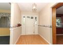 Inviting entryway with light wood floors and a decorative wallpaper border at 4141 Fallwood Cir, Orlando, FL 32812
