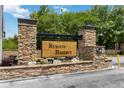 Rybolt's Reserve entrance with stone pillars and lush landscaping provides a welcoming feel at 4751 Aguila Pl, Orlando, FL 32826