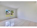 A cozy room featuring tiled flooring and a large window for natural light at 514 Richmond Ave, Deltona, FL 32725