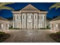 Elegant two-story home featuring well manicured landscaping and columned entryway at 6139 Greatwater Dr, Windermere, FL 34786
