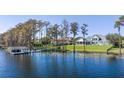 Picturesque lakefront property with a private dock, lush greenery, and stunning residence at 6139 Greatwater Dr, Windermere, FL 34786