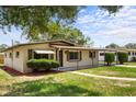 Charming single story home with well-maintained lawn, a walkway, and a covered front porch and carport at 891 N Wayman St, Longwood, FL 32750