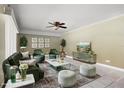 Bright living room with stylish green furniture, modern decor, and ample seating at 917 Royal Oak Blvd, Leesburg, FL 34748