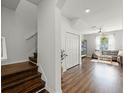 Inviting living room featuring wood floors, a staircase, and a glimpse of a cozy seating area at 10255 Hartford Maroon Rd, Orlando, FL 32827