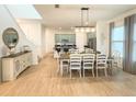 Open-concept dining area showcases elegant decor, stylish lighting, and views into the modern kitchen at 11091 Bagley Aly, Windermere, FL 34786