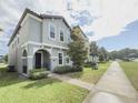 Beautiful two-story home showcases a well-maintained lawn and appealing architectural details under a partly cloudy sky at 11091 Bagley Aly, Windermere, FL 34786