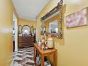 Hallway with decorative mirror and mosaic tile floor at 114 Floral Dr, Kissimmee, FL 34743
