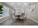 Elegant dining room featuring a round table, six upholstered chairs, and tile flooring at 1204 Howell Creek Dr, Winter Springs, FL 32708