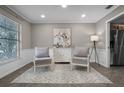 Bright sitting room featuring wainscotting and comfortable seating surrounding a bar at 1204 Howell Creek Dr, Winter Springs, FL 32708