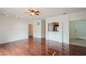 Open living area with hardwood floors, ceiling fan, and an opening to the kitchen at 122 Vista Verdi Cir # 236, Lake Mary, FL 32746