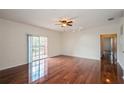 Bright living room with wood floors, ceiling fan, and a sliding glass door to the balcony at 122 Vista Verdi Cir # 236, Lake Mary, FL 32746