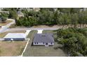 An aerial shot of the home showcasing its location, roof, and surrounding greenery at 16600 Sw 23Rd Avenue Rd, Ocala, FL 34473
