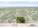 Aerial view of a charming home with mature trees and landscaping, close to amenities at 2312 Corrine Dr, Orlando, FL 32803