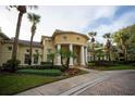 Elegant clubhouse featuring stately columns, lush landscaping, and a welcoming entrance, perfect for community gatherings and events at 2652 Robert Trend Jones # 2652, Orlando, FL 32835
