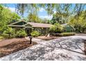 Charming ranch home with lush landscaping, paver walkway, and a spacious driveway at 2705 Curryville Rd, Chuluota, FL 32766