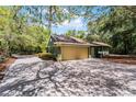 Detached garage with large driveway and lush greenery, offering ample parking at 2705 Curryville Rd, Chuluota, FL 32766