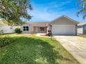 Charming single-story home with well-maintained lawn and landscaping, plus attached two-car garage at 2708 La Posada Dr, The Villages, FL 32162