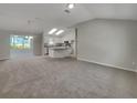 View of the spacious, light-filled living room and kitchen with modern appliances and natural light at 2708 La Posada Dr, The Villages, FL 32162